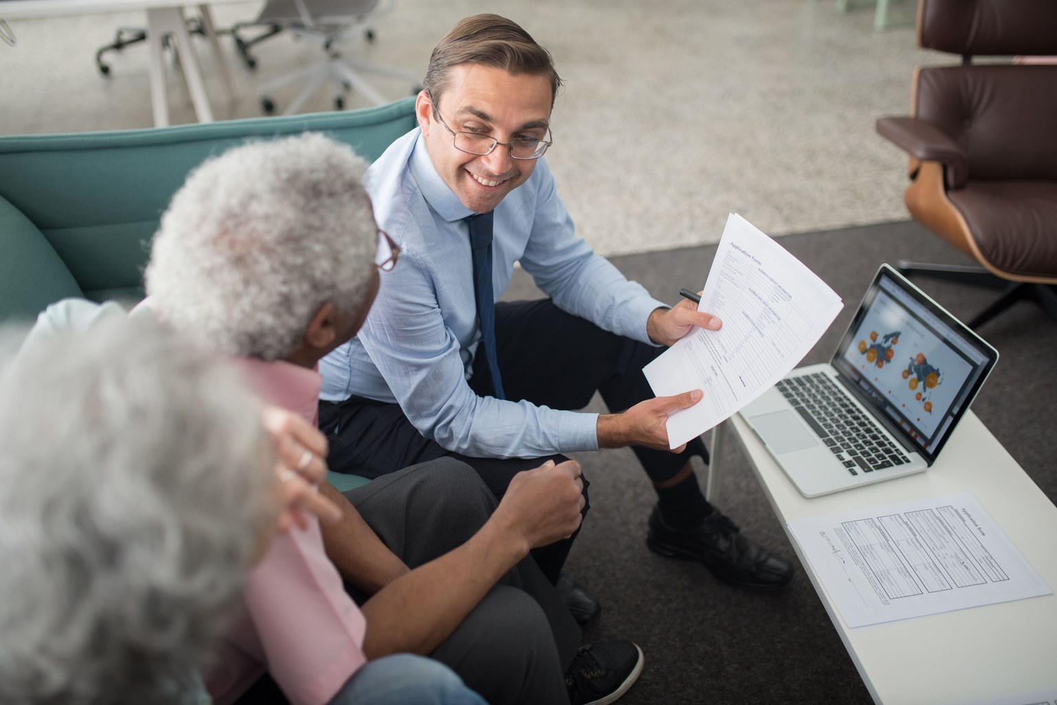 An adviser discussing documents with older clients
