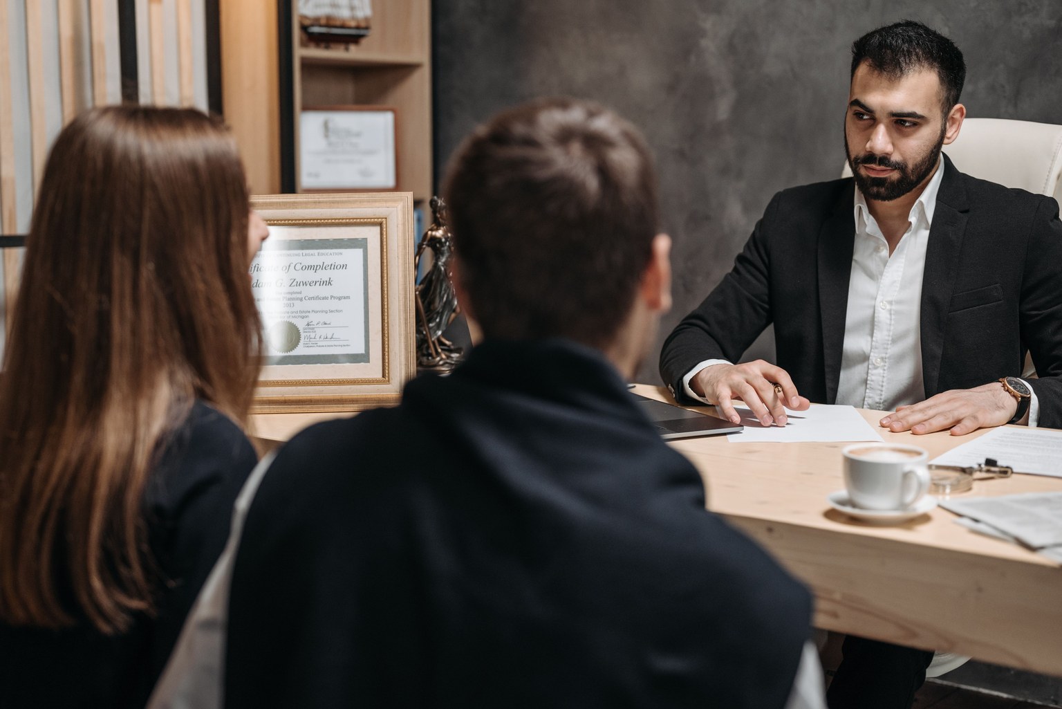 A professional advising clients across a desk
