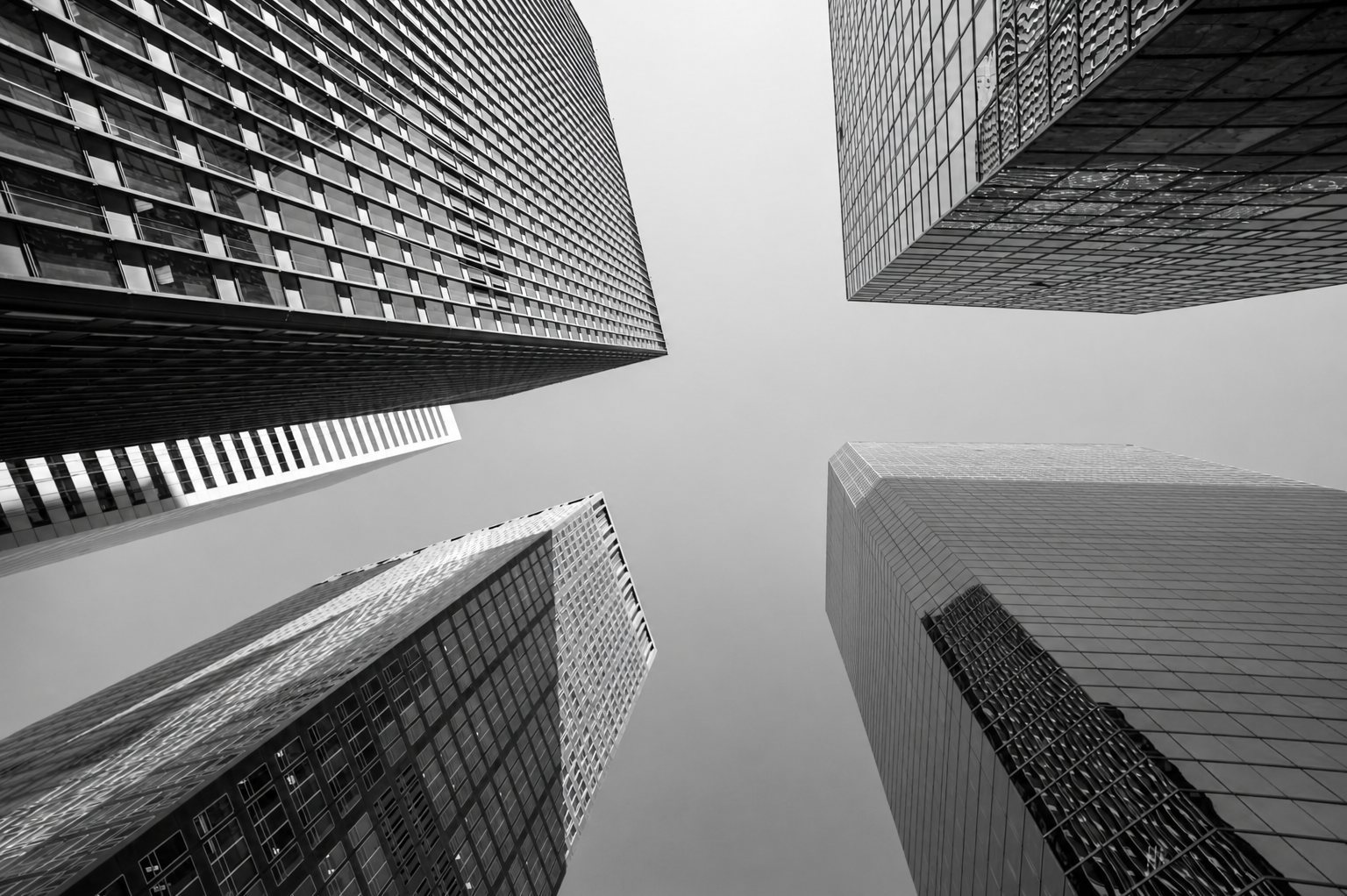 Upward view between enduring buildings