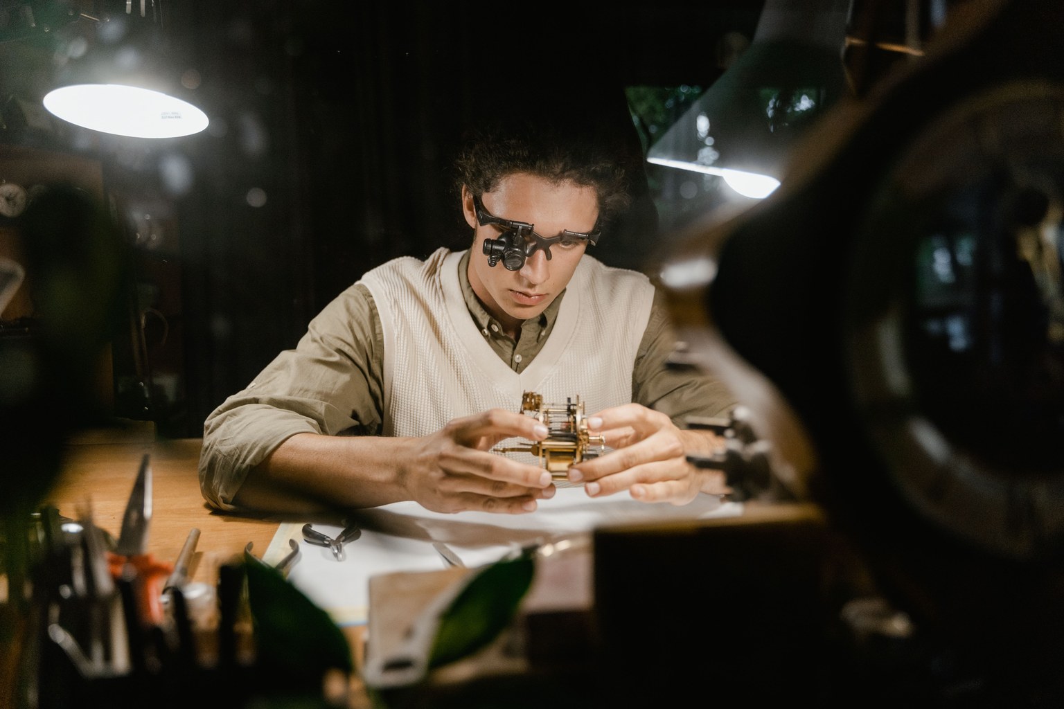 A watchmaker working carefully with a precision mechanism